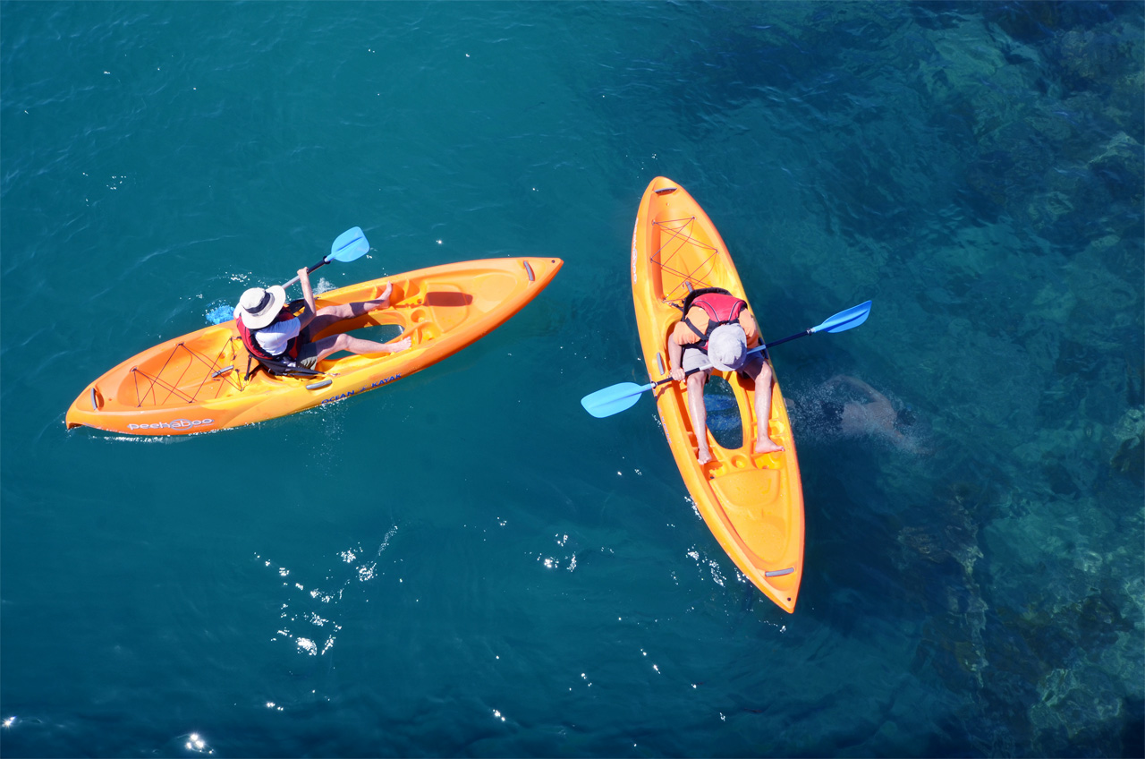 Easy Kayaks glass-bottom kayaks viewed from above over reef water